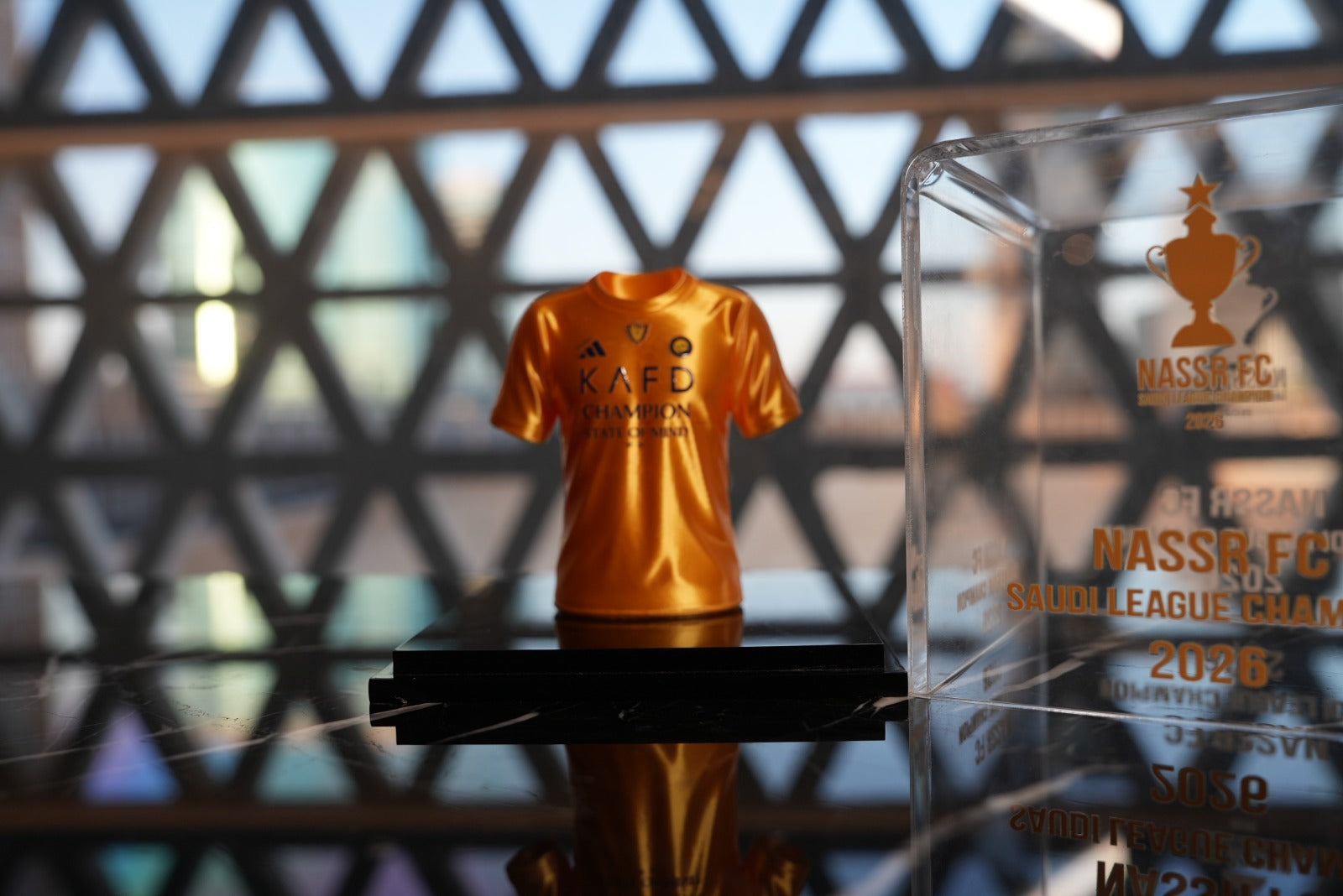Al Nassr FC Saudi League Champion 2026 mini jersey in acrylic display case — front view