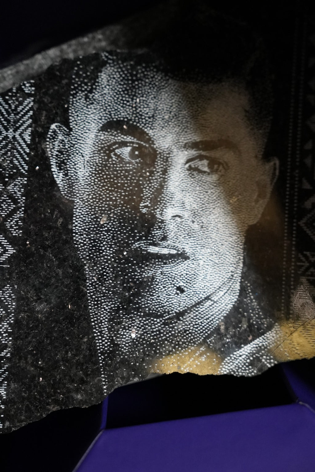Al Nassr FC dot-engraved black stone portrait — extreme close-up showing pointillist detail and player's gaze