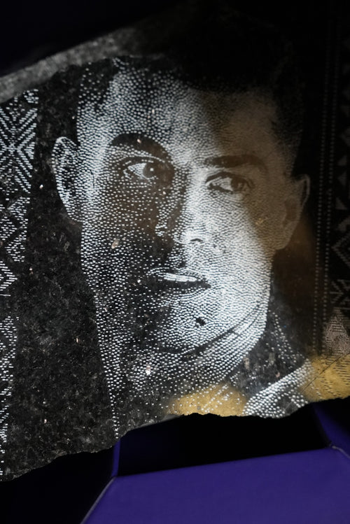 Al Nassr FC dot-engraved black stone portrait — extreme close-up showing pointillist detail and player's gaze